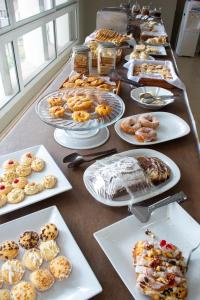 a long table with many plates of food on it at Hotel Centro in Santiago del Estero