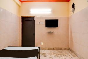 Zimmer mit einem TV an der Wand in der Unterkunft Hotel O D Stay Inn in Rushikonda + 17 Fotos