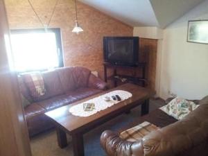 a living room with a couch and a coffee table at Reiterstübchen in Kuchelmiß +8 photos