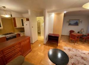 a living room with a kitchen and a dining room at Lodgia Apartments in Skorka
