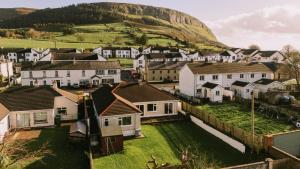 a village with houses and a hill in the background at Strandhill House in Carrowbunnauna