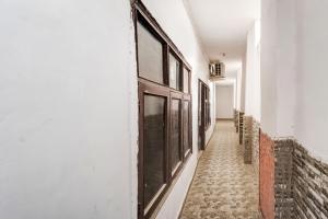 a corridor of a building with a door on the side at SPOT ON Gorav Smark in Malhour