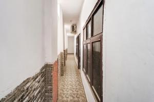 an empty hallway with white walls and a door at SPOT ON Gorav Smark in Malhour +51 photos