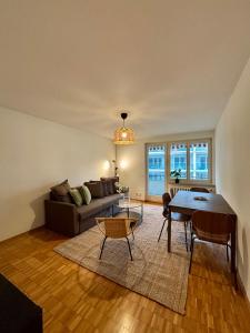 a living room with a couch and a table at Live Zurich in Cozy Apartment in Zürich