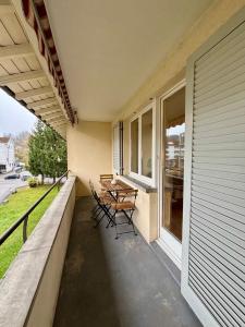 a porch with chairs and a table on a house at Live Zurich in Cozy Apartment in Zürich +2 photos