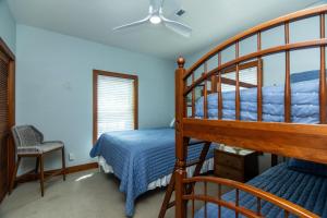 a bedroom with a bunk bed and a staircase at Sound Choice in Edisto Island