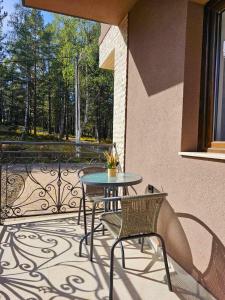 a patio with a table and chairs on a balcony at Vila Vujic Tara in Kaludjerske Bare