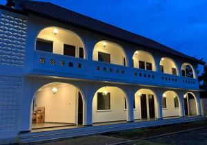 a blue and white building with arches at Naungan Intaran Mandala in Sanur