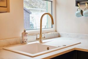 a sink in a kitchen with a window at Host & Stay - Daisy Cottage in Masham +30 photos