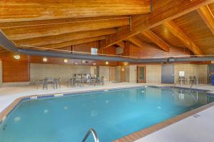 a swimming pool in a building with wooden ceilings at Best Western Plus McCall Lodge and Suites in McCall