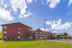 a large red building with a green lawn in front at Best Western Plus McCall Lodge and Suites in McCall
