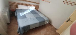 a small bedroom with a bed in a room at Appartamento Santa Sofia in Padova