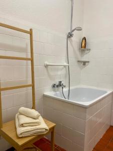 a bathroom with a tub and a shower with towels at Teatro Inn - Timeless Charm in Correggio +27 photos
