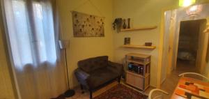 a living room with a chair and a television at Appartamento Santa Sofia in Padova +11 photos