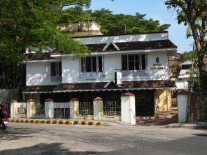 a white building on the side of a street at Casa Linda in Cochin +43 photos