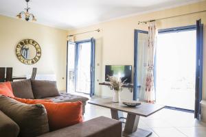 a living room with a couch and a table at Villa Xenia in Karavadhos