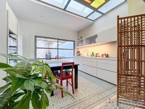 a kitchen with a table and a potted plant at Anavel Atao in Lille