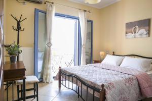 a bedroom with a bed and a large window at Villa Xenia in Karavadhos +10 photos
