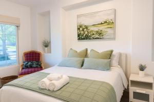 a bedroom with a bed with a towel on it at #Marbella Lane - Lit & Laid Back Eastvale Home in Corona