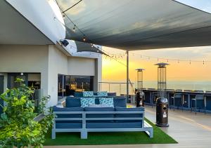 a blue couch sitting on top of a balcony at MNM Luxury Suit 424A in Pretoria