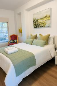 a bedroom with a large white bed in a room at #Marbella Lane - Lit & Laid Back Eastvale Home in Corona