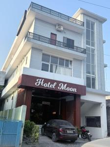 a car parked in front of a hotel room at The Hotel Moon in Pāonta Sāhib