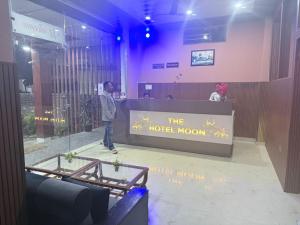 a man standing at a hotel room counter at The Hotel Moon in Pāonta Sāhib