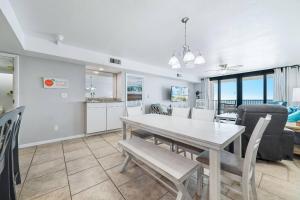 a dining room and living room with a table and chairs at Wind Drift 408SW in Perdido Key