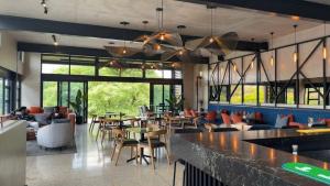 a restaurant with a bar and tables and chairs at Waterfall luxe apartment in Kyalami