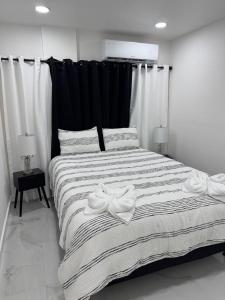 a bedroom with a large bed with two towels on it at Apartment in Tampa