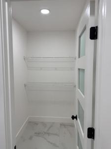 a white walk in closet with a white door at Apartment in Tampa +6 photos
