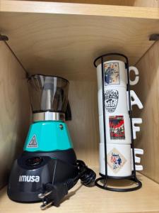 a blender and a snowboard on a shelf at Apartment in Tampa