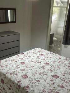 a bedroom with a bed and a dresser and a bathroom at Sitio Encantos do Vale in Major +28 photos