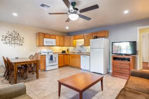 a kitchen with a table and a white refrigerator at Pine-Santa Fe by Roundhouse Resort and Spa in Indian Pine