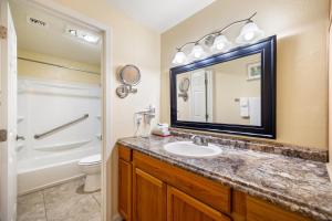 a bathroom with a sink and a toilet and a mirror at Pine-Santa Fe by Roundhouse Resort and Spa in Indian Pine +11 photos