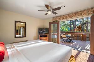 a bedroom with a large bed and a balcony at Pine-Santa Fe by Roundhouse Resort and Spa in Indian Pine
