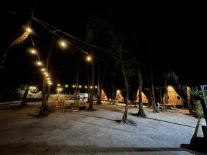 a park at night with trees and lights at Teepee Hut Fan room in San Felipe