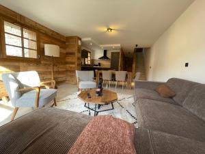 a living room with a couch and a table at Duplex Haut de Gamme neuf - 10 personnes - App 004 in Saint-Sorlin-dʼArves