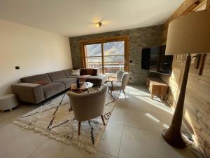 a living room with a couch and a table at Duplex Haut de Gamme neuf - 10 personnes - App 004 in Saint-Sorlin-dʼArves