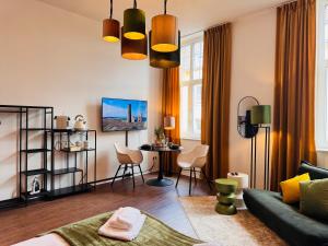 a living room with a couch and a table at Klassen Stay - Exklusive Altbau Apartments - Zentral - Rheinnähe in Koblenz