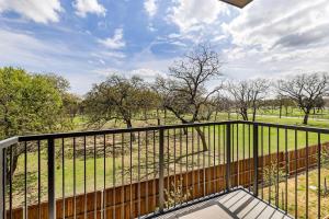 a balcony with a view of a field at Landing Apartments - Denton in Denton