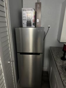 a refrigerator with a box on top of it at Guest house 7 mins From stadium in Opa-locka