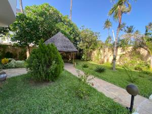a garden with a gazebo in a yard at Watamu House in Watamu