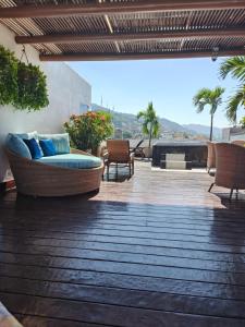 a patio with a couch and chairs on a deck at Condominio Panamá in Puerto Vallarta +107 photos