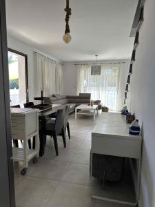 a living room with a table and a couch at Aphrodites Resident in Paphos +11 photos