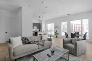 a living room with a couch and a table at Landing Apartments - Denton in Denton