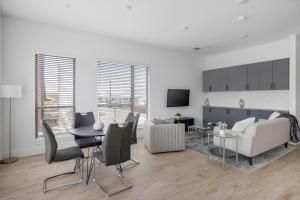 a living room with a couch and a table and chairs at Landing Apartments - Denton in Denton