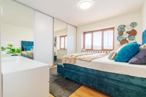a bedroom with a bed and a mirror at B-Home Apartments in Trenčín