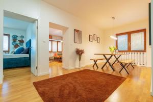 a living room with a table and a bed at B-Home Apartments in Trenčín