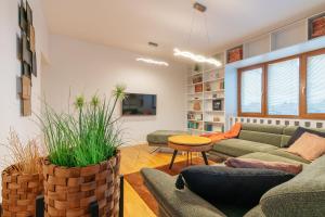 a living room with couches and a table at B-Home Apartments in Trenčín